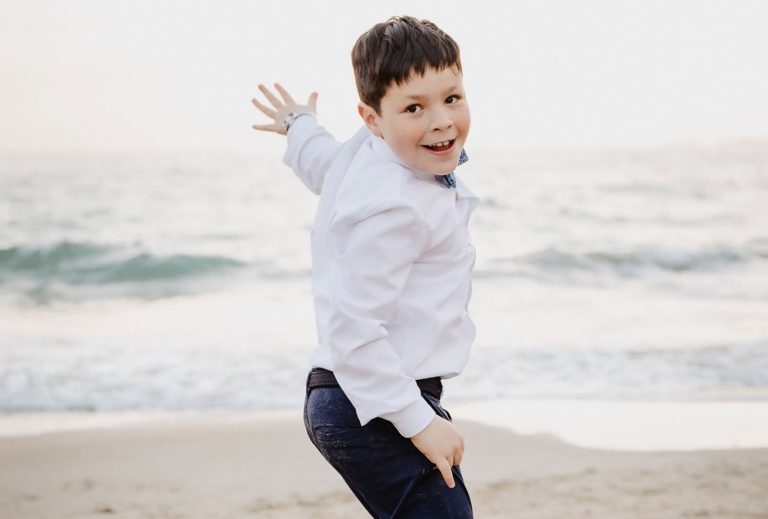 Niño de la comunión en la playa